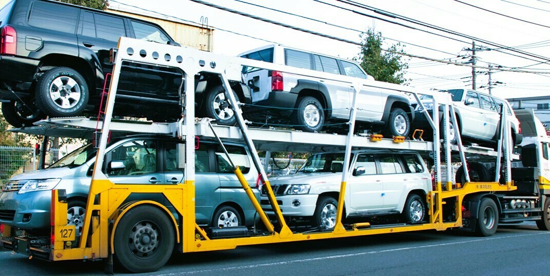 Is it safe to transport a car in an open trailer?