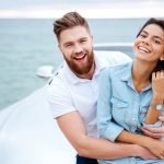 graphicstock happy smiling couple on a date standing near car at the seaside BOWOe8hrng