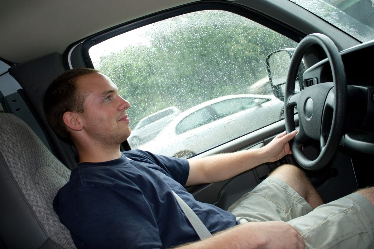 interior view of a young man driving a van or truck shallow depth of field SFoi3KABj